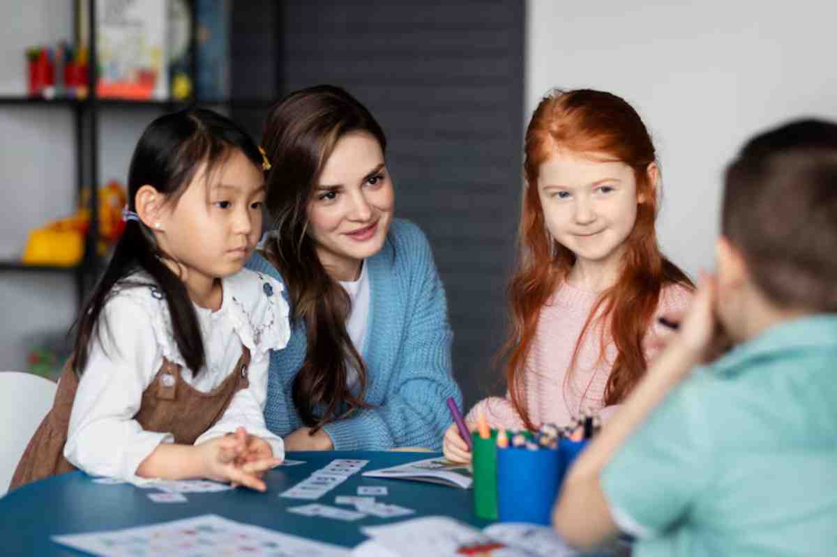 Four children and a woman engage in a colorful arts and crafts activity at a table, surrounded by supplies and playful decor.
